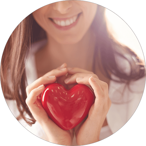 Smiling woman holding a red heart